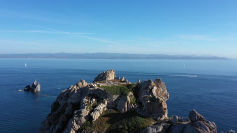 Man-standing-on-a-cliff-Cap-Medes-Porquerolles-aerial-shot-summer-Hyeres-island